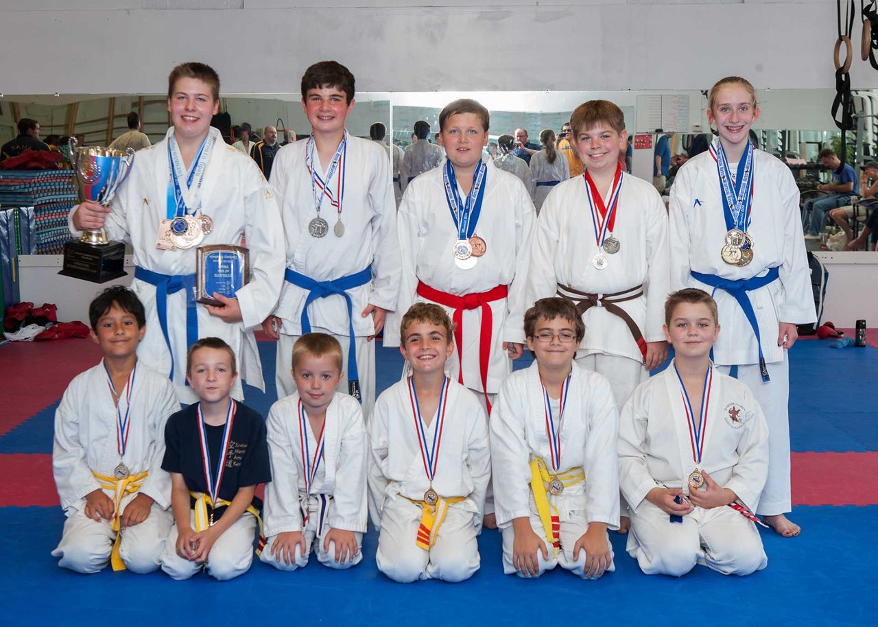 SMAK Dojo youth team with medals and trophies