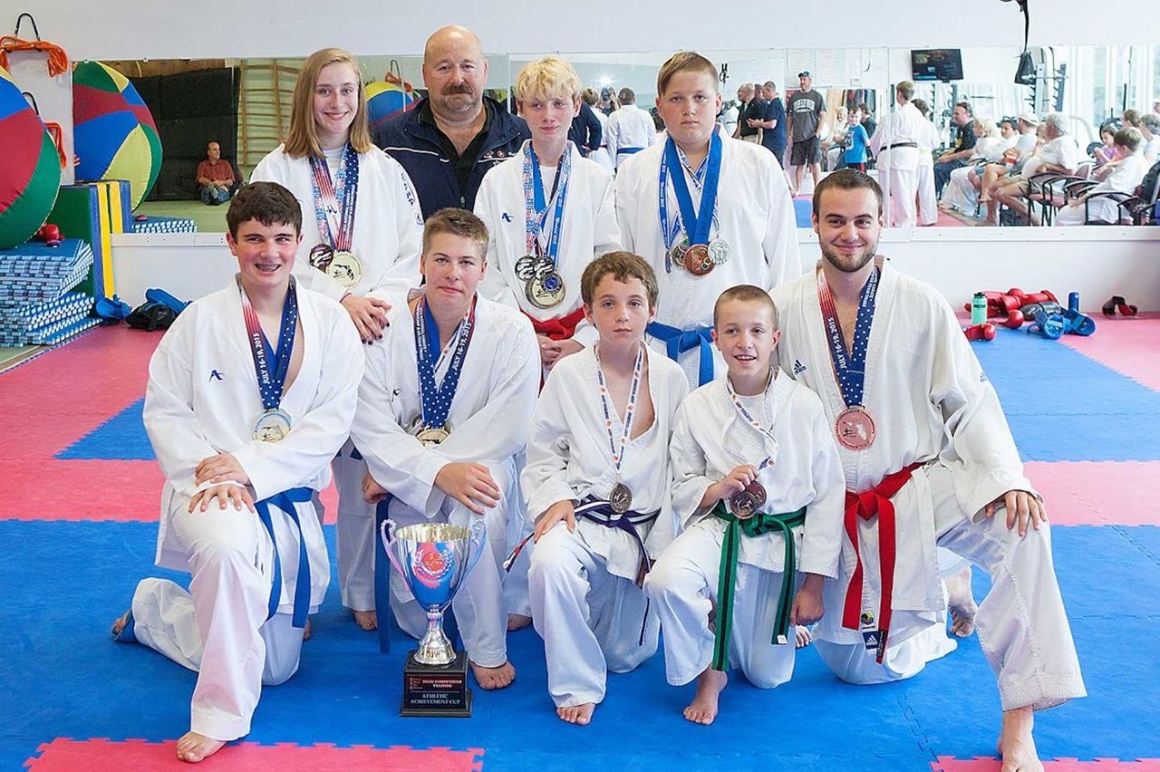 Competitors with trophy and medals
