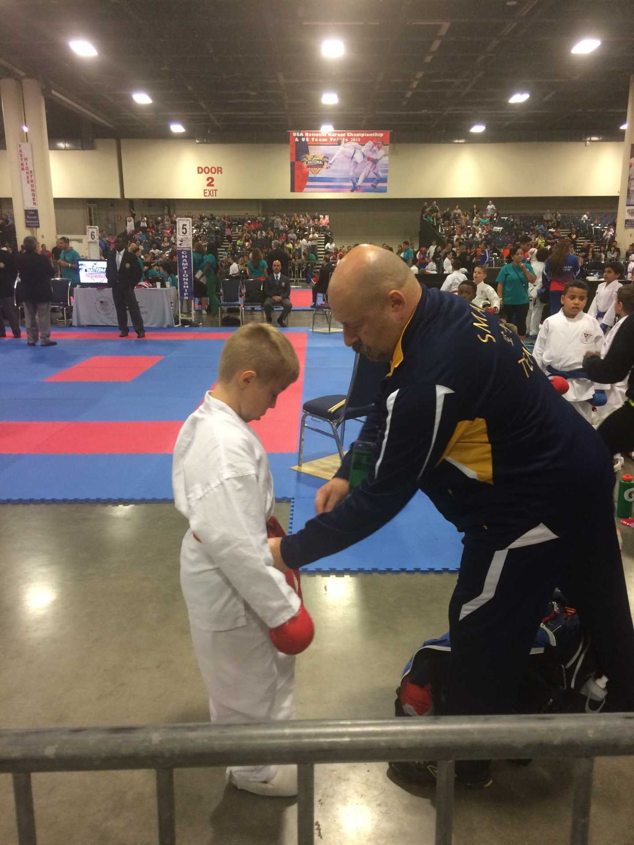 Instructor coaching a student on a competition floor