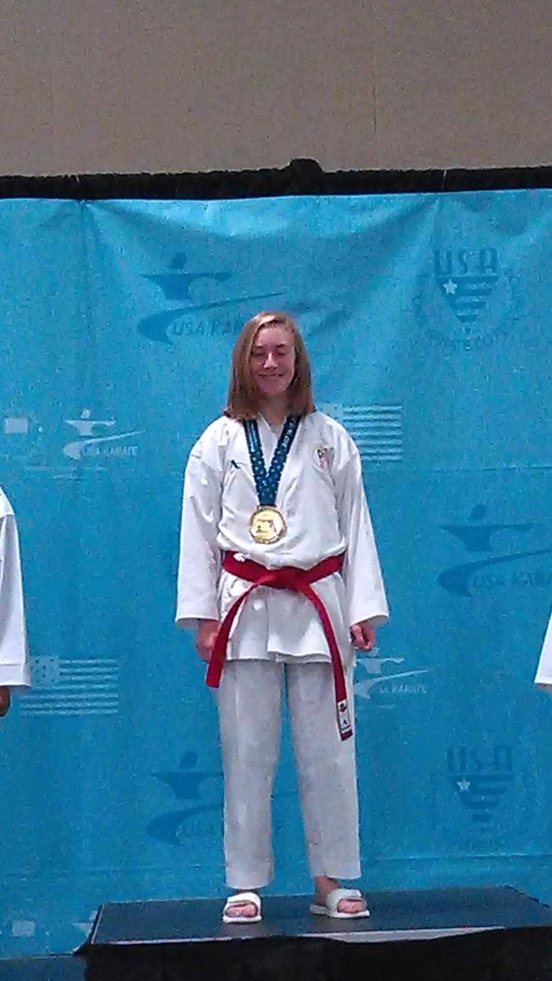 Competitor on the podium with a medal